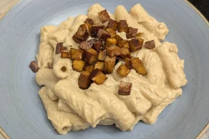 Cremige Käsenudeln vegan und high Protein mit Tofu-Bacon-Würfel als Topping.
